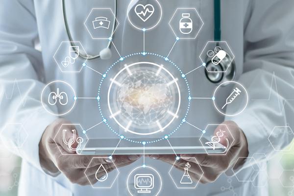 Photo of medical person using tablet with Invita software. Holographic digital icons hovering.