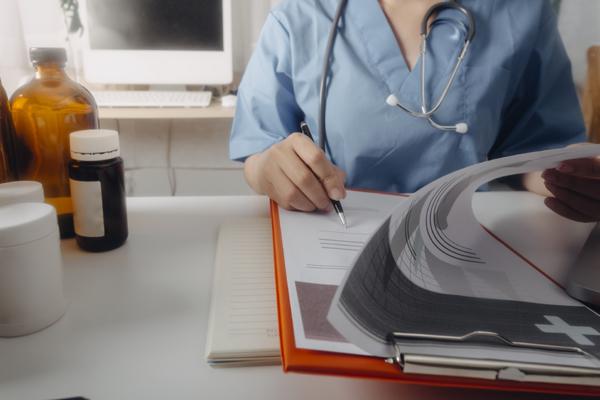 Photo of doctor reviewing and signing documents.s