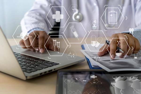 Photo of medical person using InVita software on laptop.