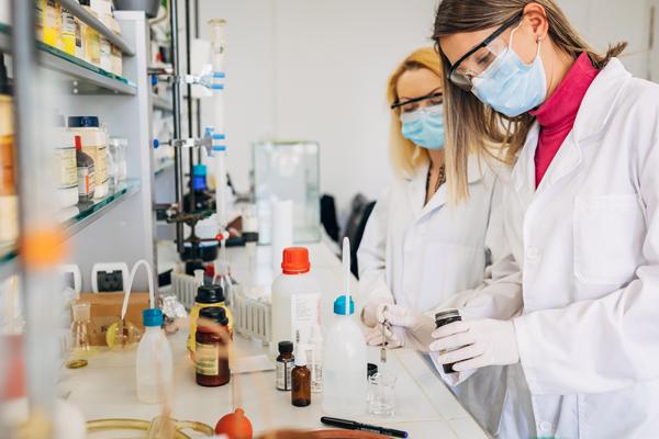 photo of medical lab technicians testing samples.