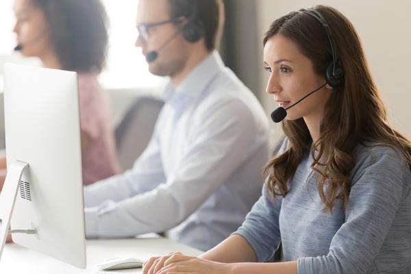 Photo of female customer service representative looking at monitor.