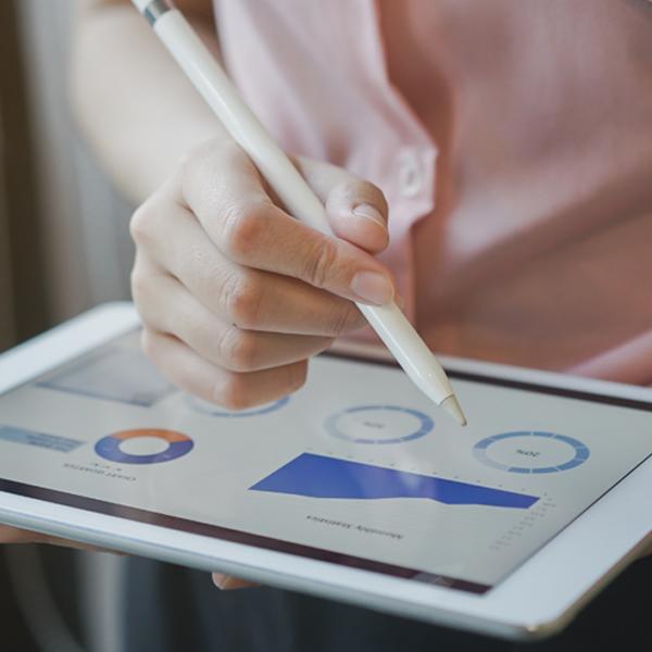 Photo of hand using Invita software on tablet.
