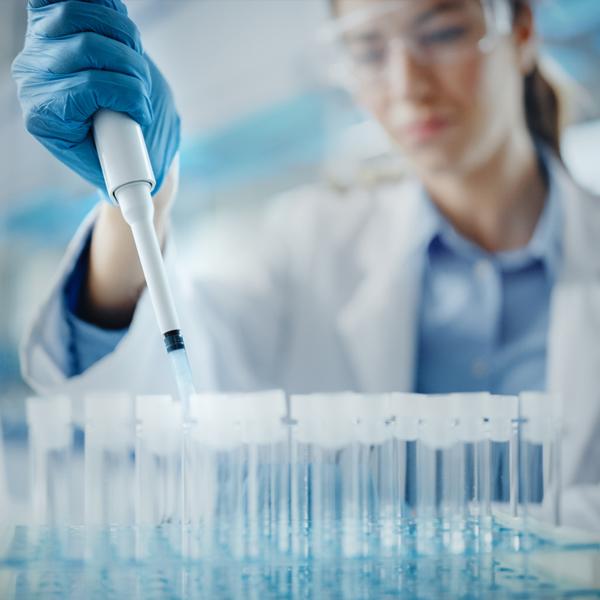 Lab techznicians examining DNA in microscope.